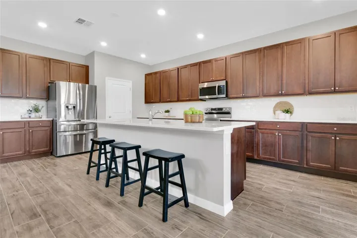 Large quartz island with bar seating.