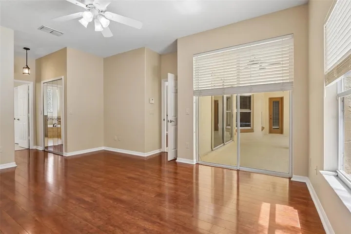 The spacious Primary Suite is a true private retreat, offering sliding glass doors to the lanai, dual closets—including a generous walk-in—and a SPA-INSPIRED EN SUITE BATH.