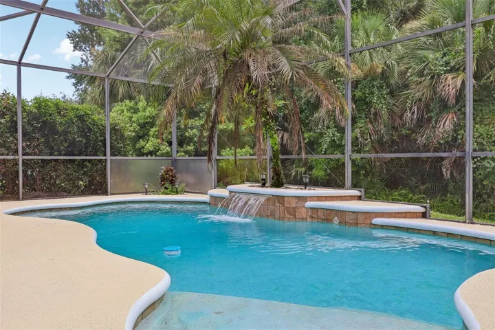 Enjoy your own BACKYARD OASIS with a covered patio and sparkling in-ground pool with a beautiful WATERFALL FEATURE.