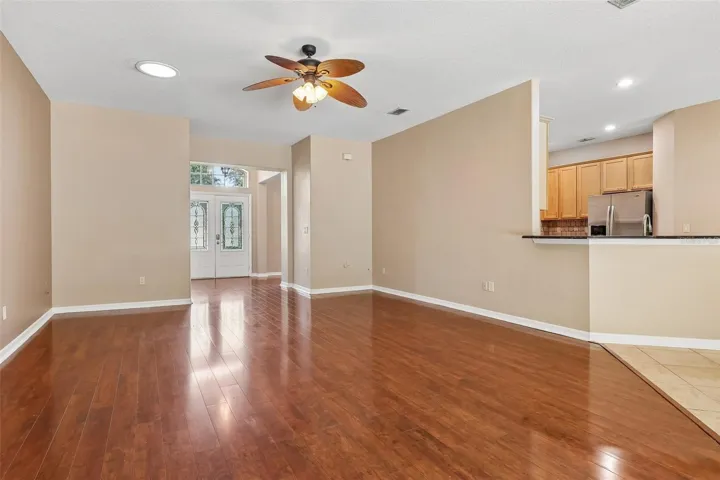 The spacious OPEN-CONCEPT living area, where the Kitchen and Living Room flow seamlessly together, boasts two solar tubes, expansive sliding glass doors, and an abundance of NATURAL LIGHT creating an airy, welcoming atmosphere