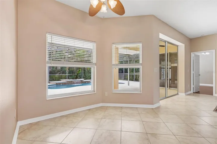 The adjoining breakfast nook surrounded by windows overlooking the pool, makes every meal feel special.