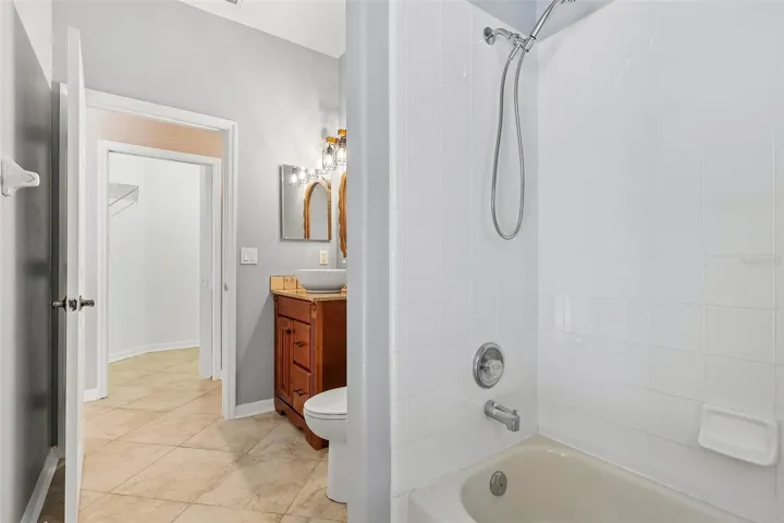 A SPACIOUS FULL BATH also provides direct access to the pool, making it ideal for outdoor entertaining.