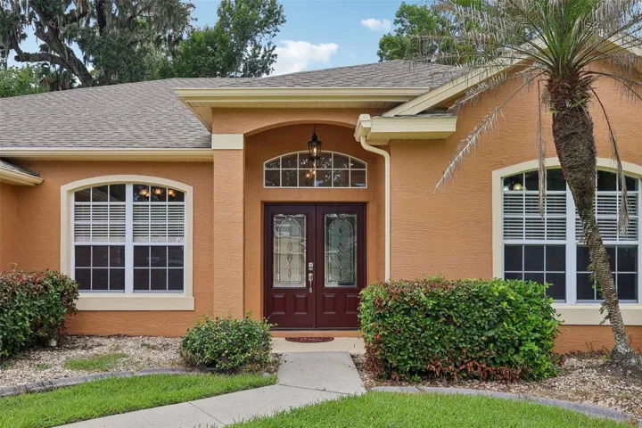 Outstanding curb appeal welcomes you home with lush landscaping, a manicured lawn, FRESH EXTERIOR PAINT, and a NEW ROOF (2022).
