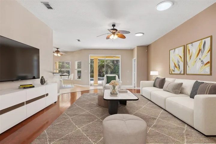 The spacious OPEN-CONCEPT living area, where the Kitchen and Living Room flow seamlessly together, boasts two solar tubes, expansive sliding glass doors, and an abundance of NATURAL LIGHT creating an airy, welcoming atmosphere. Virtally Staged