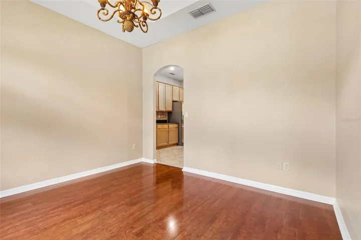 A formal Dining Room makes an elegant first impression with its ARCHITECTURAL TRAY CEILING and graceful arched entryway.