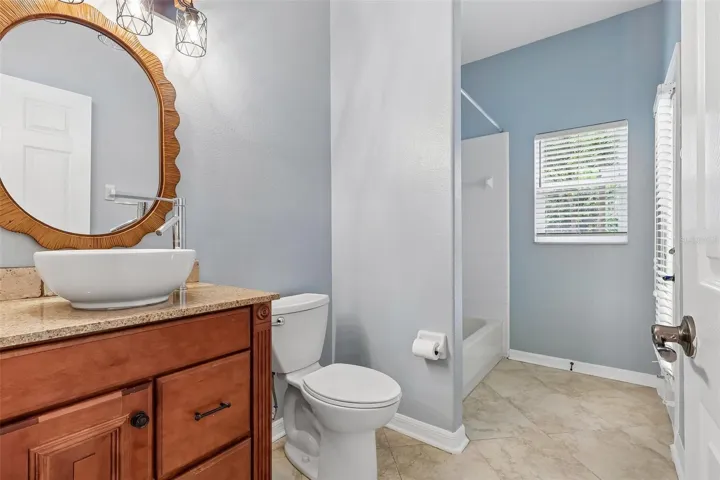 A SPACIOUS FULL BATH also provides direct access to the pool, making it ideal for outdoor entertaining.