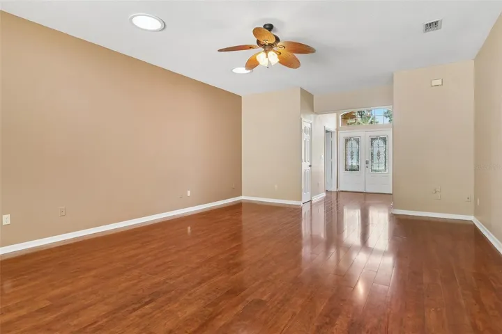 Step through the ELEGANT ETCHED-GLASS DOUBLE FRONT DOORS beneath soaring ceilings into a bright, inviting interior where beautiful WOOD-LOOK LAMINATE FLOORING, fresh interior paint throughout—including the closets, woodwork, garage walls, and pool deck—and stylish NEW LIGHT FIXTURES create a fresh, modern feel.