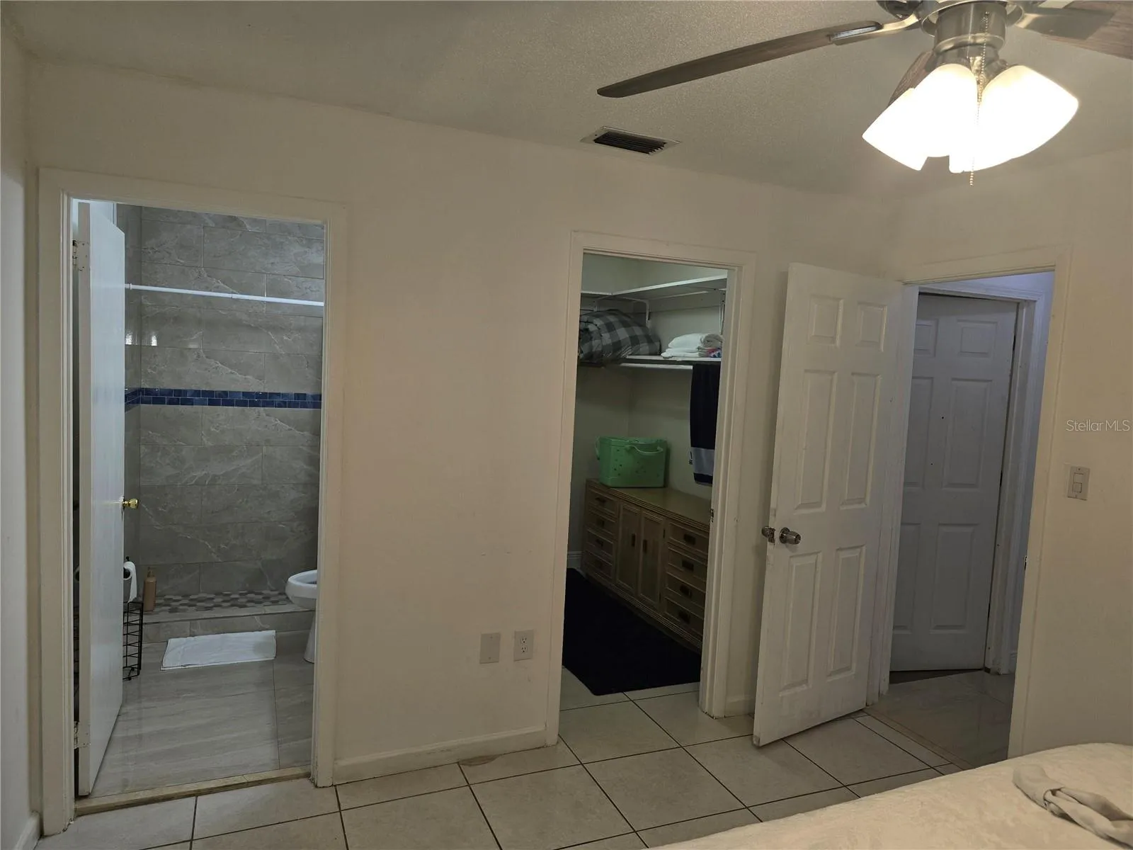 Master bath, closet and entrance to bedroom