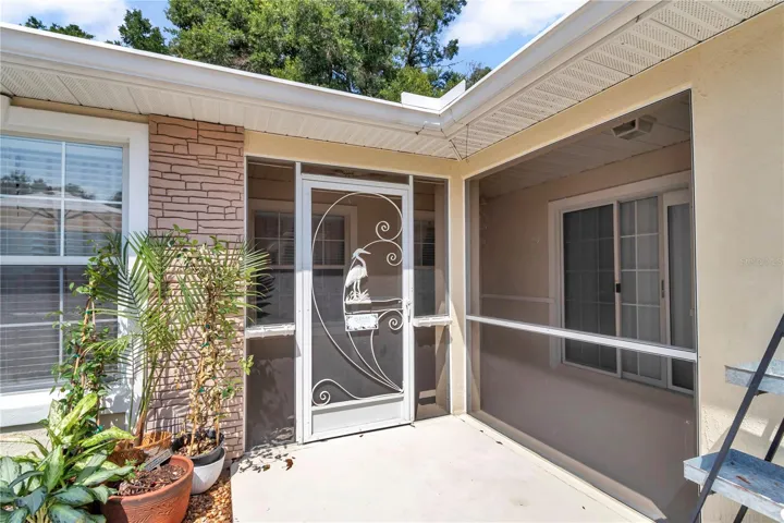 Screened lanai leads to front door