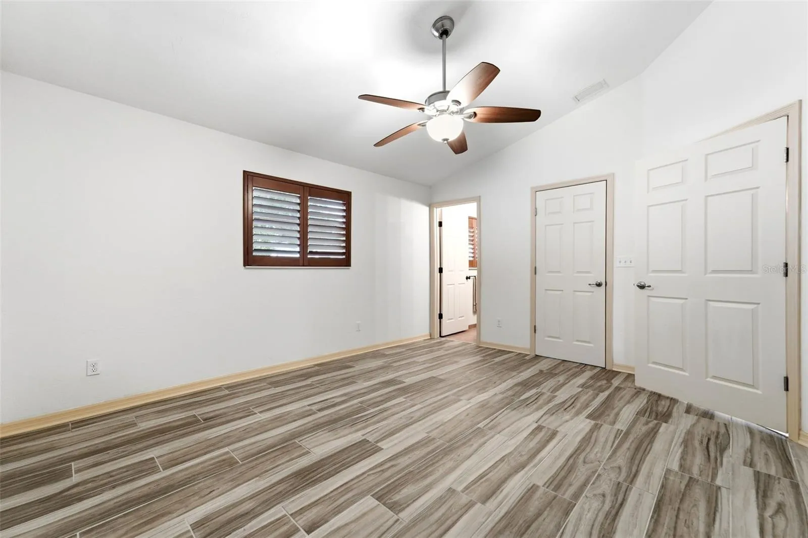 A spacious owner's suite filled with natural light and calming finishes.