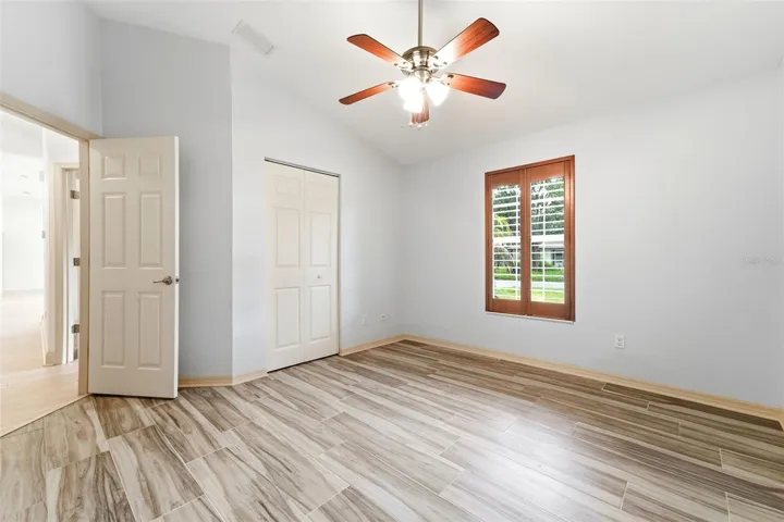 Bedroom two with built in closet and plantation shutters.