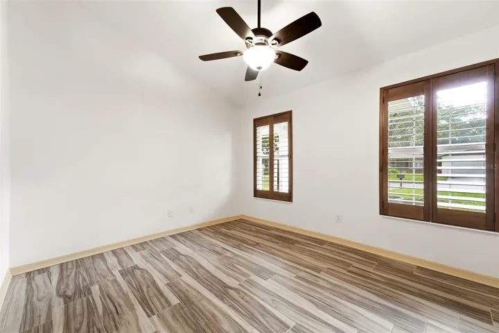 Plantation shutters and vaulted ceilings add warmth and character throughout.
