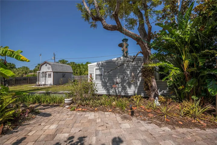 THREE sheds, decorative pond, paver patio walkway, gardens, fenced yard... a dream come true for a gardener, landscaper, mechanic, hobbyist...