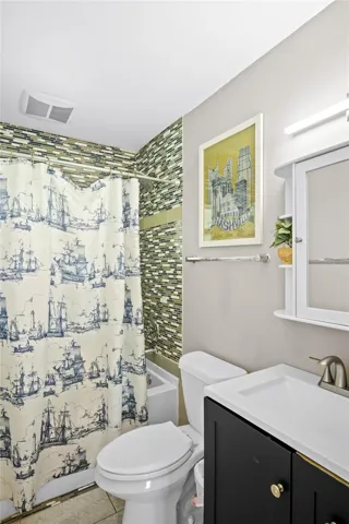 The bathroom has a tub and shower.