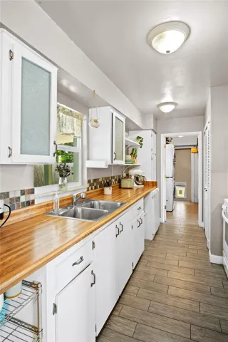The kitchen leads to the laundry room and the third bedroom.