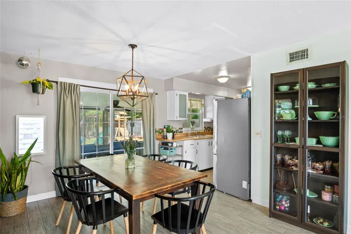 The dining area is located between the family room and the kitchen.  It overlooks the screened in patio and pool area.