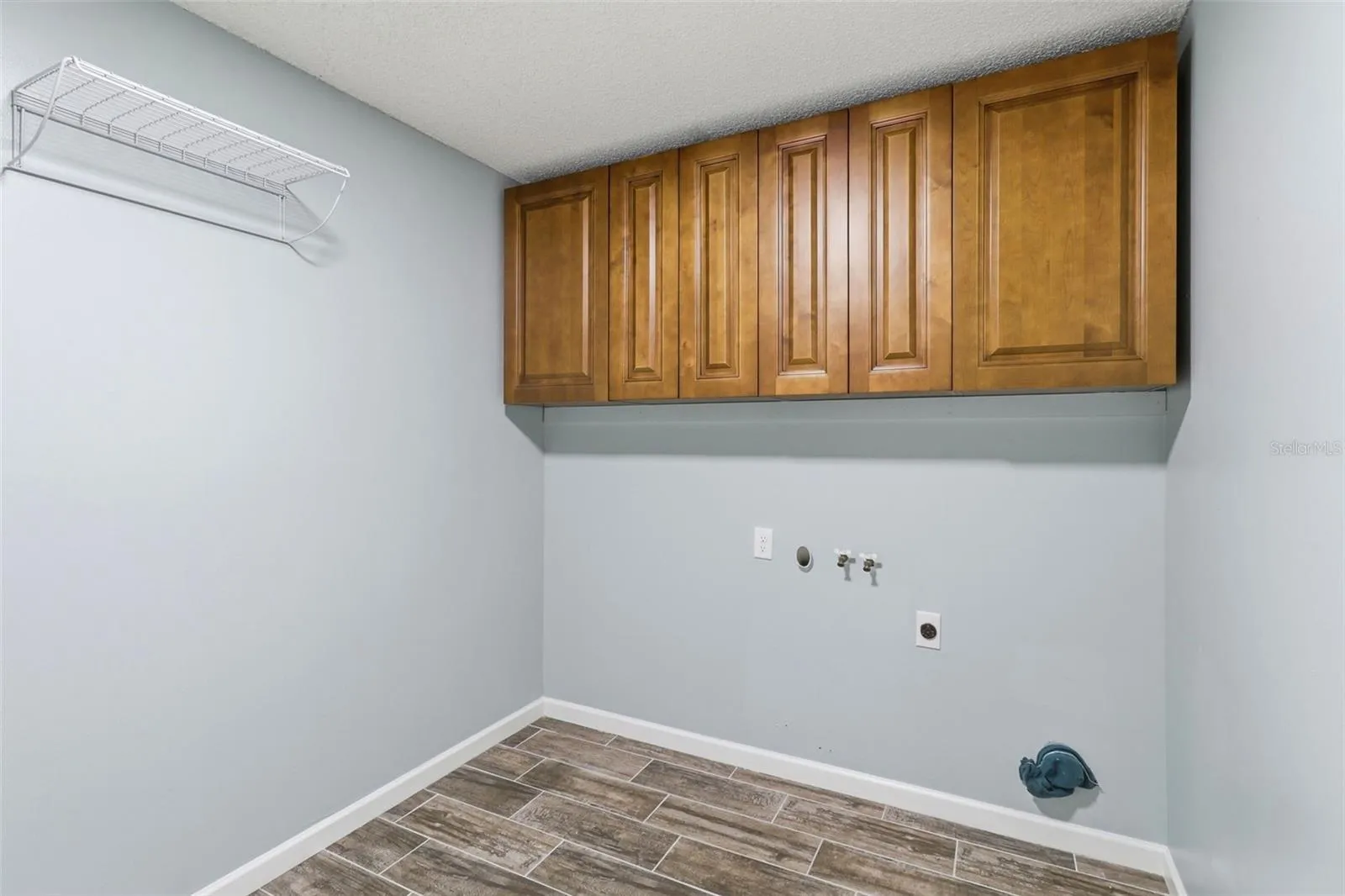 Inside Laundry room with storage and door to garage