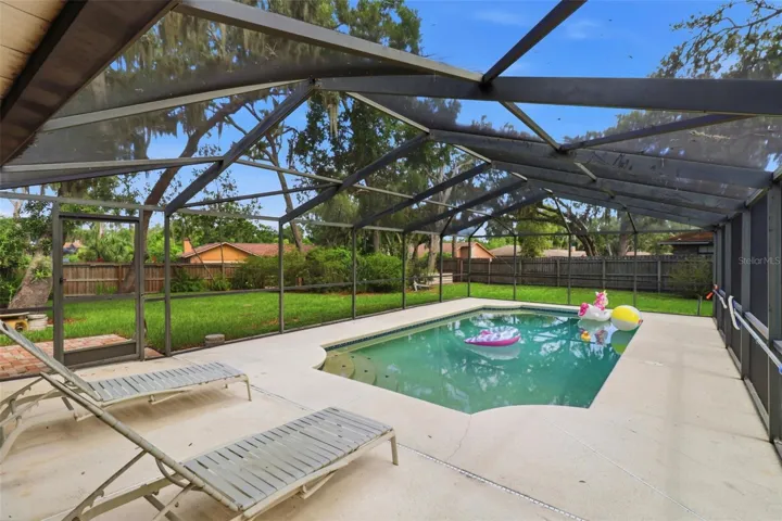 Beautiful pool and view of large private backyard