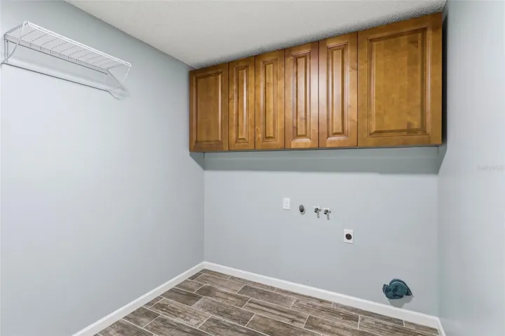 Inside Laundry room with storage