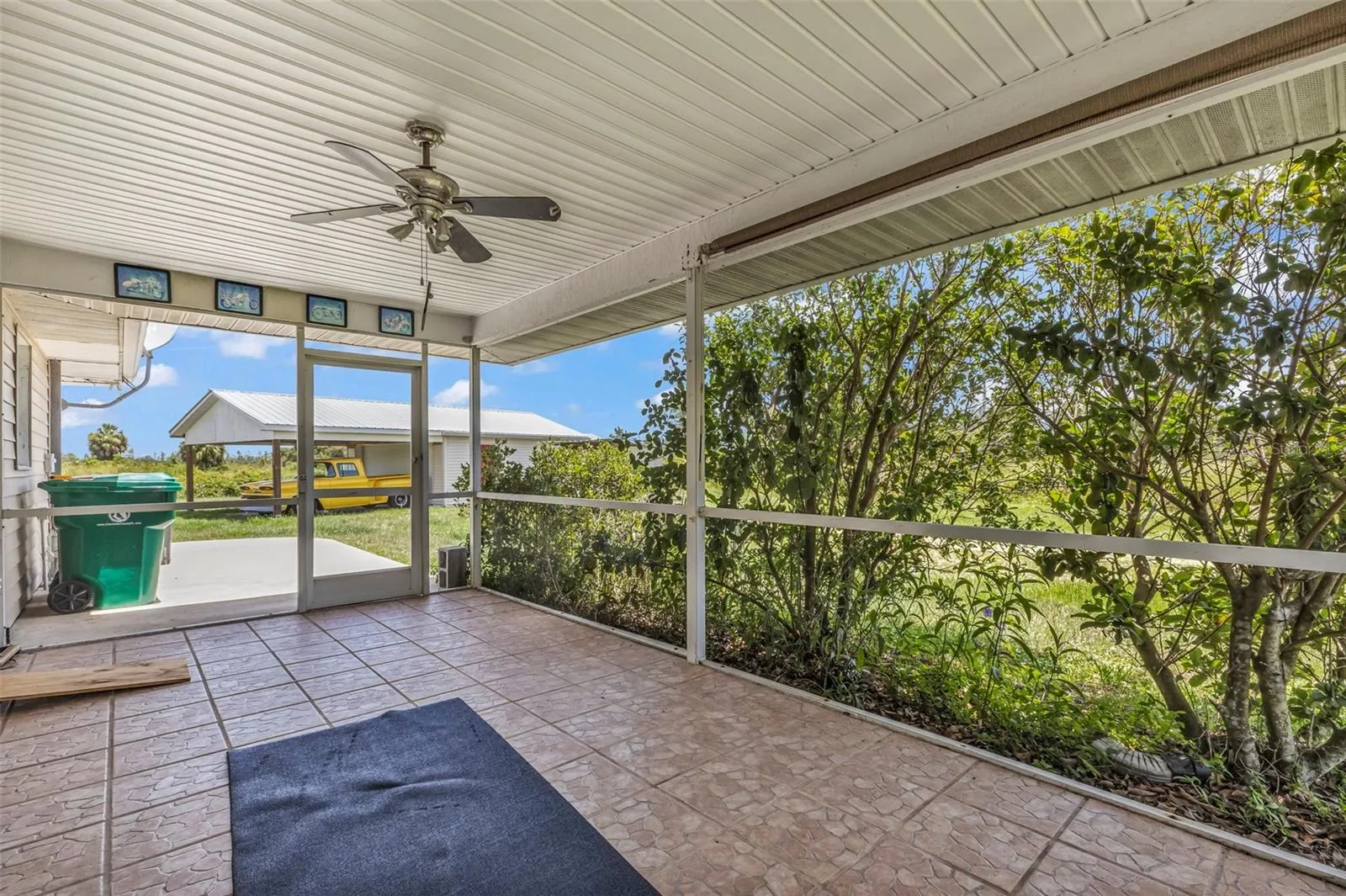 Large screened back patio with shades