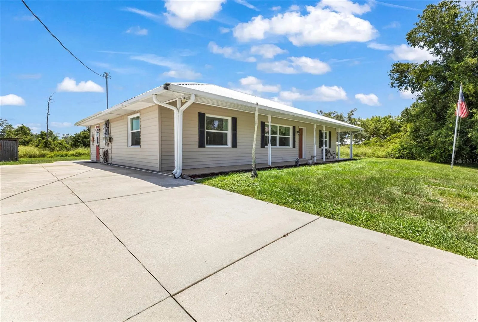 Oversized parking pad/driveway with side entrance into home.
