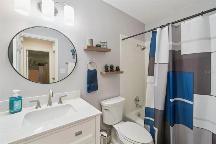 Guest bathroom with new vanity, mirror and flooring.