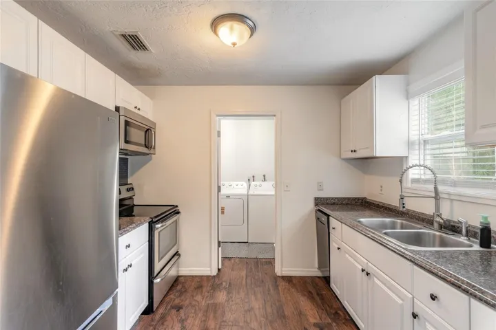 laundry room at the end of the kitchen with exterior door