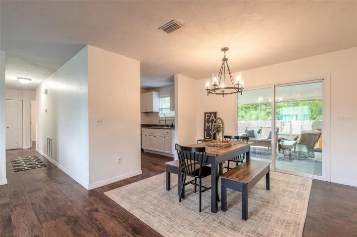 Dining + down the hall to the bedrooms and sliders to the back patio (screen enclosed)