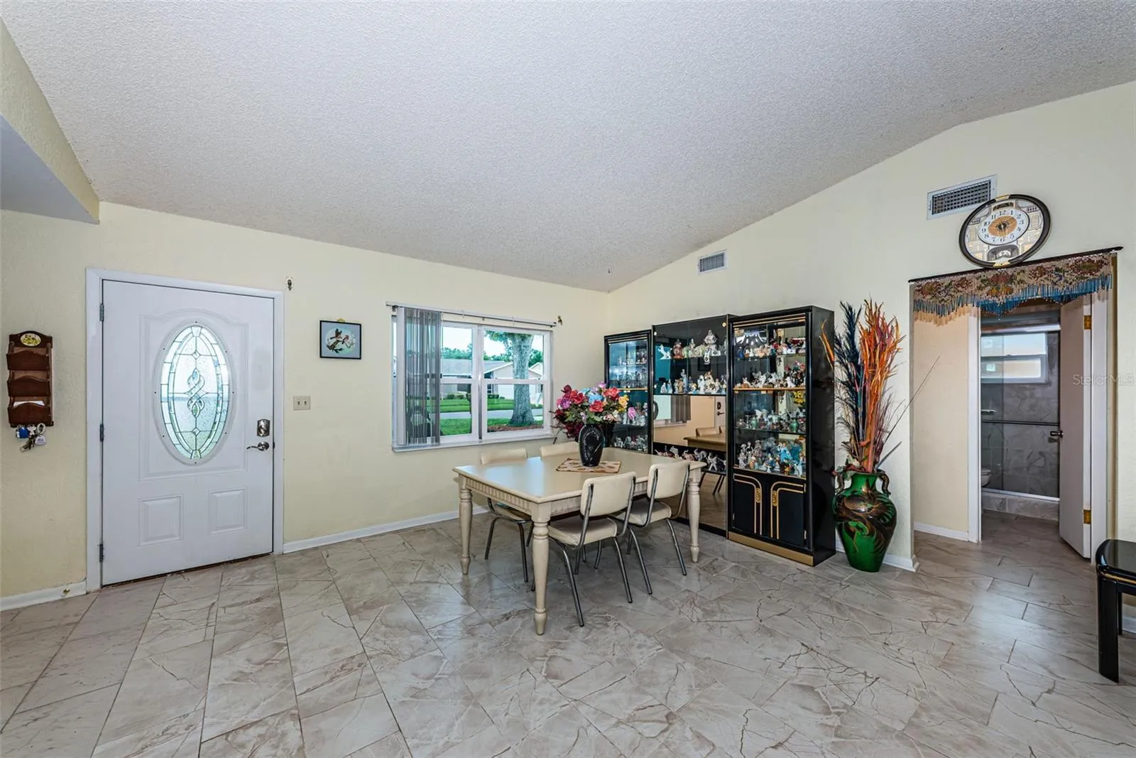 Living and dining room with access to the guest bathroom and 2 bedrooms.