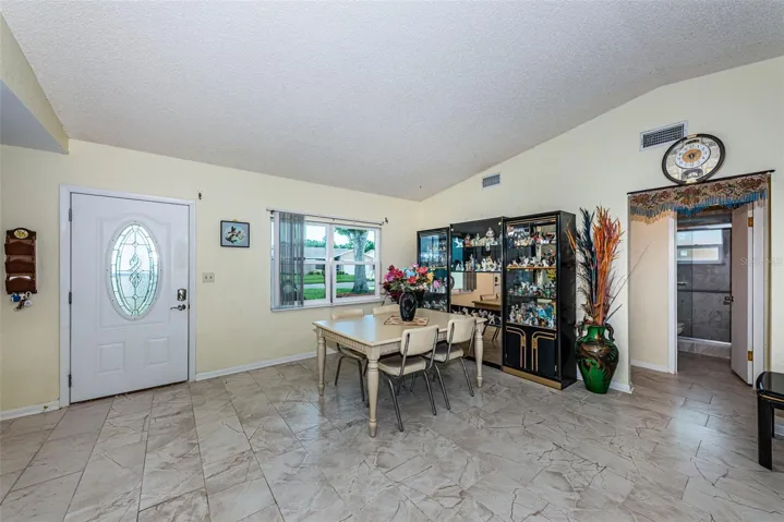 Living and dining room with access to the guest bathroom and 2 bedrooms.