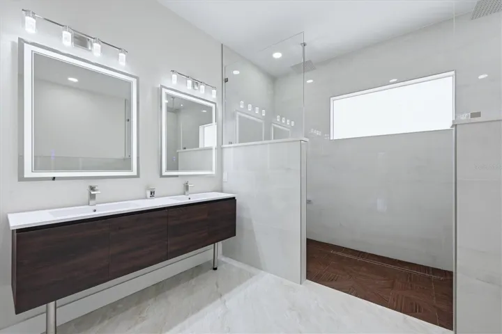 Ensuite with dual sinks and shower w/bench