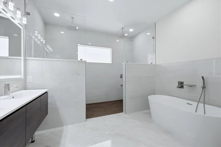 Ensuite w.large shower, multiple shower heads and transom window. Soaking tub and dual sink vanity with lighting sensored mirrors