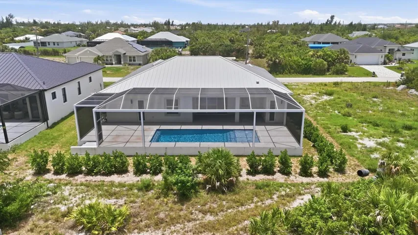 Drone shot of rear of home and pool