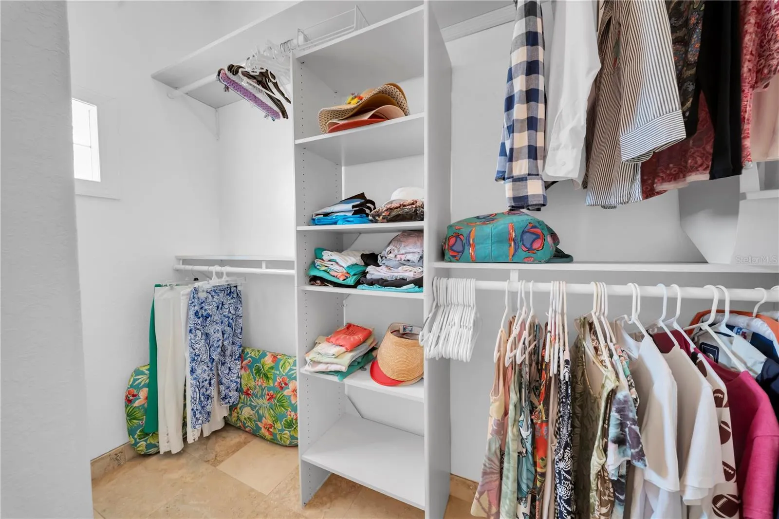 One side of Primary walk in closet
