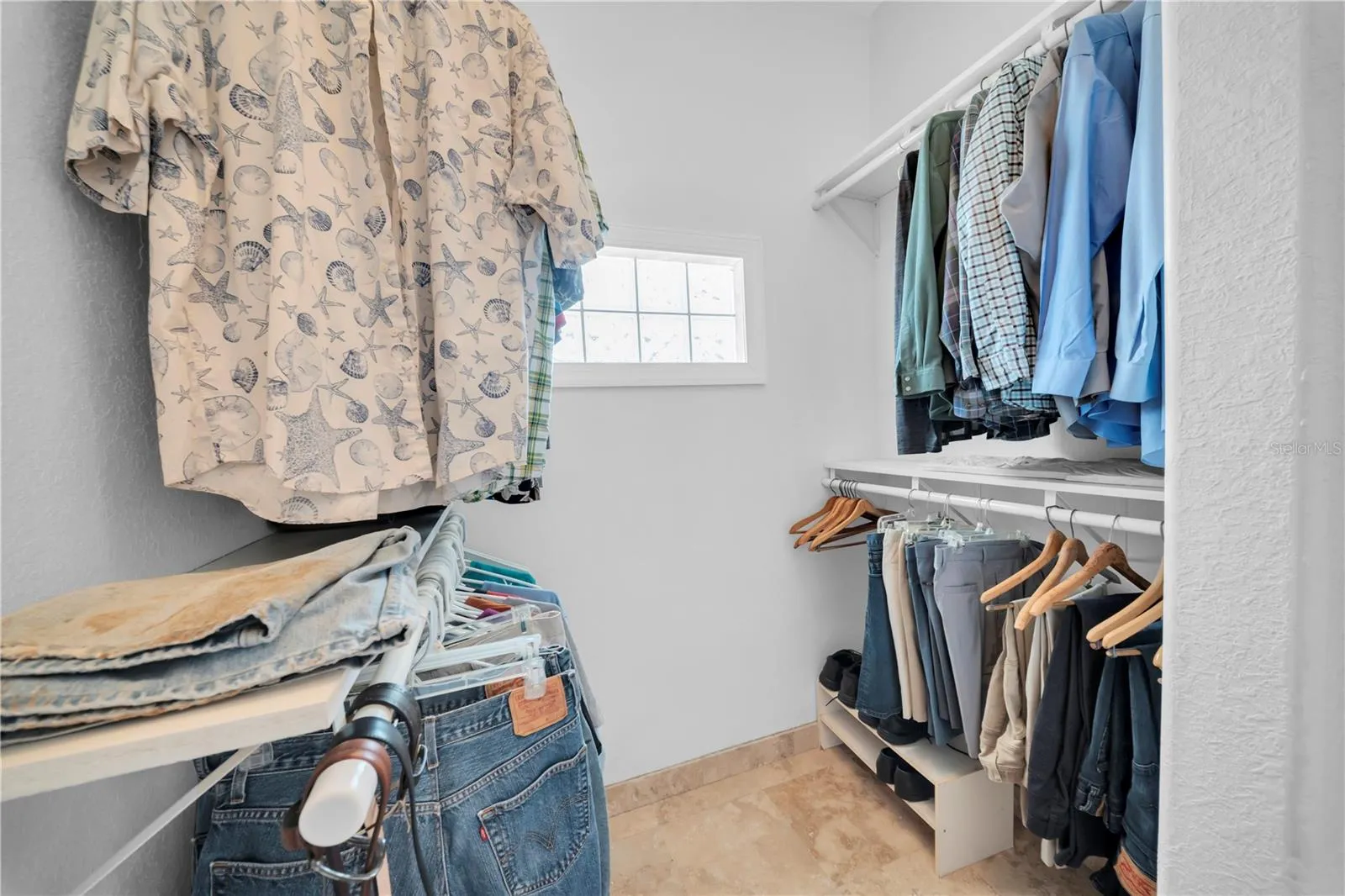 One side of Primary walk in closet