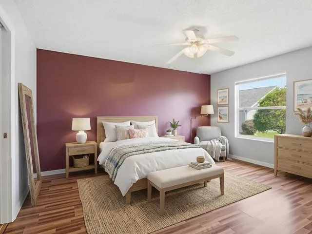 Virtually staged Primary Bedroom with big window and 2 walk in closets.