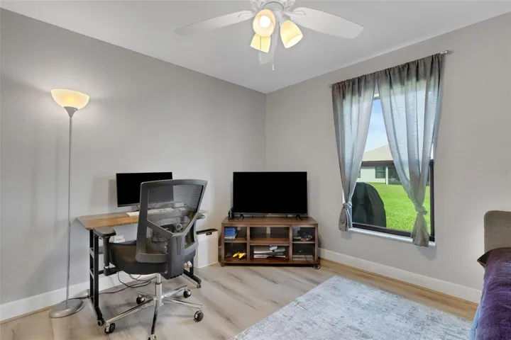 Bedroom #3 has wood laminate flooring and large window overlooking the backyard.