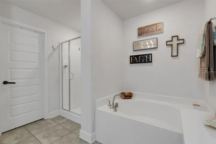 Plus, a deep garden tub for soaking and separate glass enclosed shower and adjacent walk-in closet.