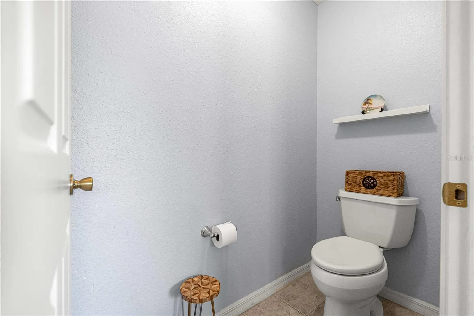 Toilet room behind door in primary bath