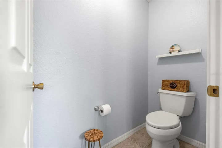 Toilet room behind door in primary bath