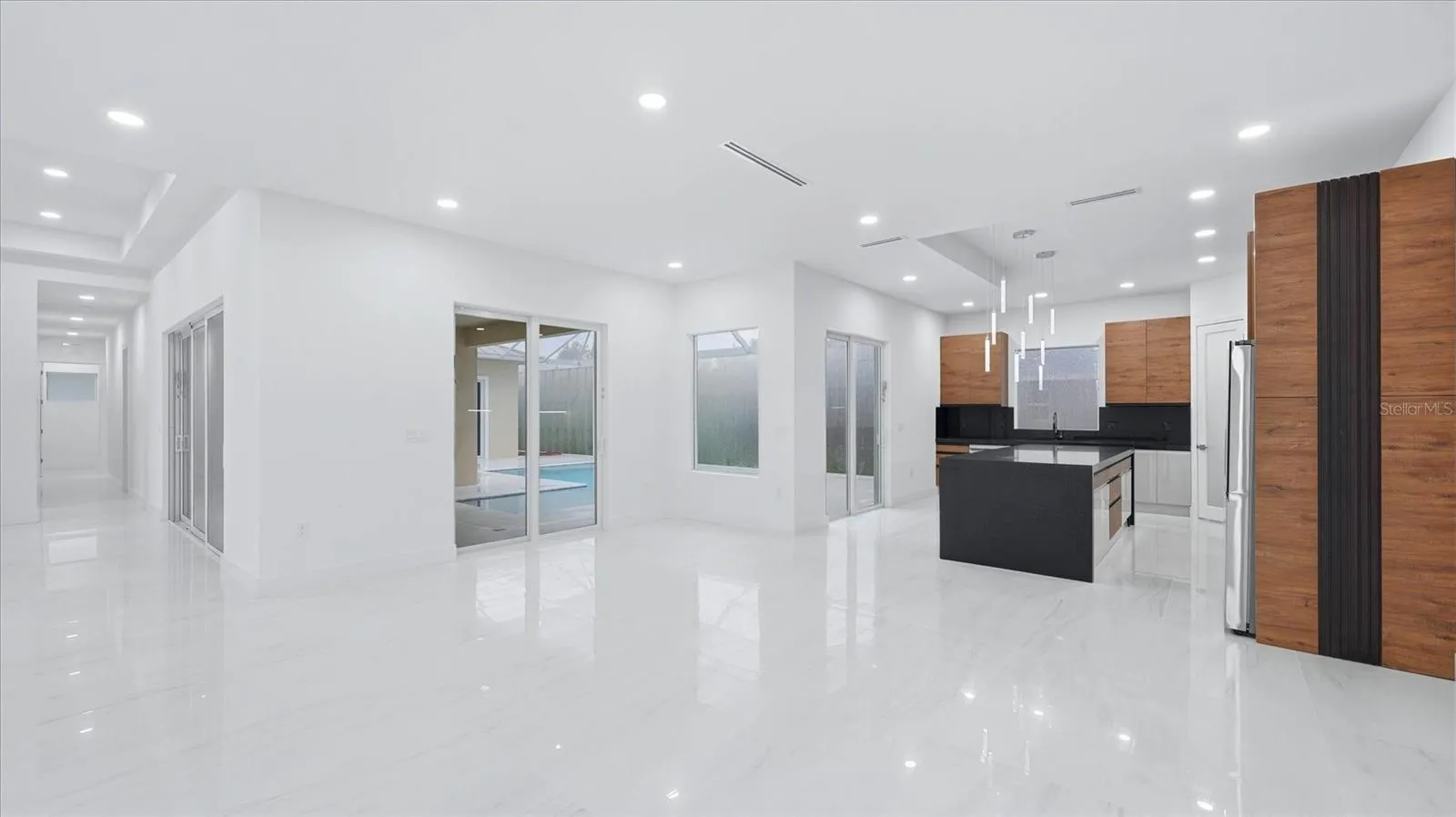View from living area to sliders and pool