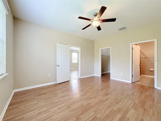 Primary bedroom with walk-in closet and en suite bathroom