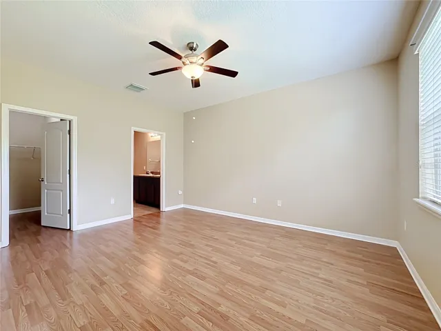 Primary bedroom with walk-in closet and en suite bathroom