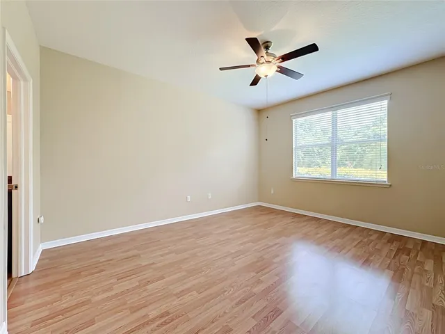 Primary bedroom with walk-in closet and en suite bathroom