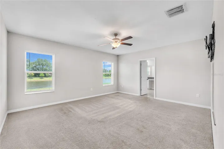 Tucked away at the rear of the home for added privacy, the spacious first-floor owner's suite serves as a peaceful retreat with a large walk-in closet and a private en-suite bathroom designed for comfort and convenience.