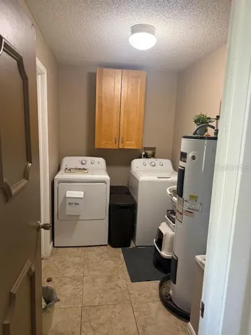 Interior laundry room, storage and access to garage.