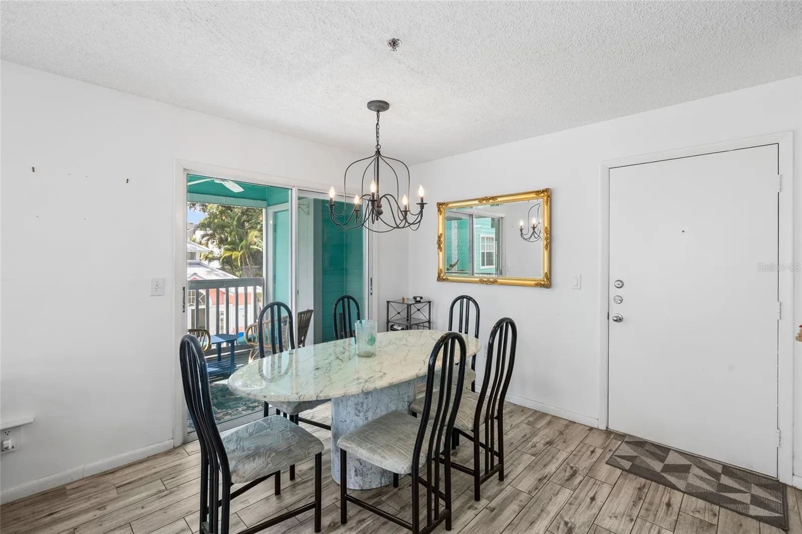 Dining room overlooking balcony &amp; pool area