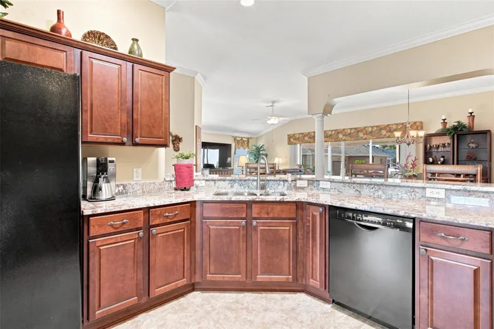 Kitchen features granite countertops, plenty of cabinets space, solar tube for natural light while overelooking the dinette area, living area, and dining area.