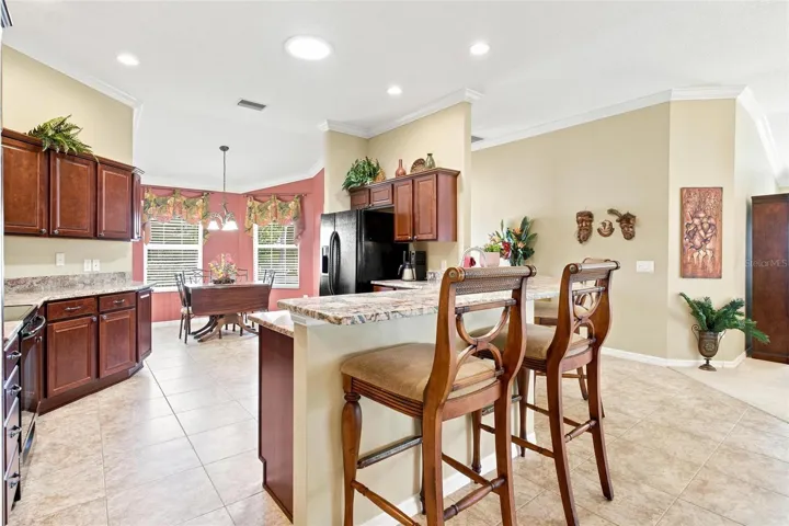 Kitchen features granite countertops, plenty of cabinets space, solar tube for natural light while overelooking the dinette area, living area, and dining area.