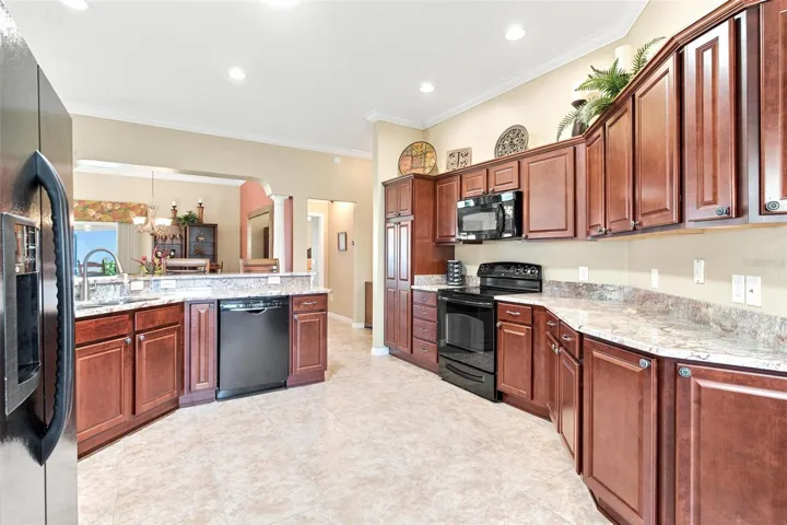Kitchen features granite countertops, plenty of cabinets space, solar tube for natural light while overelooking the dinette area, living area, and dining area.